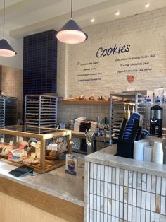 a counter with some food on it and lights hanging from the ceiling in front of them