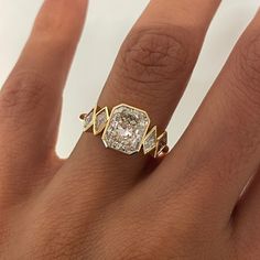 a woman's hand with a diamond ring on it