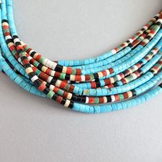 Hand-strung Multi-strand Turquoise Necklace Gift, Artisan Single Strand Turquoise Beads, Artisan Turquoise Necklace With Heishi Beads For Gift, Artisan Hand-strung Heishi Beads Necklace, Traditional Turquoise Single Strand Beaded Necklaces, Traditional Turquoise Single Strand Beaded Necklace, Traditional Turquoise Beaded Necklaces With Spacer Beads, Traditional Turquoise Single Strand Jewelry, Traditional Turquoise Beaded Necklace With Spacer Beads