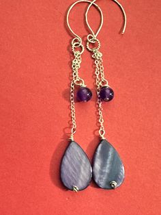 Amazing color...I've used MOP purple teardrop Briolettes (25x13mm). Amethyst rounds (6mm), sterling silver link chain, wirewrapped in sterling silver wire as they dangle from hammered earwires. The length is adjustable as you loosen the knot. Total length is up to 3.7". Magnificent... Nickel Free Briolette Teardrop Earrings In Sterling Silver, Nickel-free Briolette Teardrop Sterling Silver Earrings, Purple Sterling Silver Teardrop Dangle Earrings, Purple Sterling Silver Teardrop Earrings For Gift, Handmade Amethyst Teardrop Earrings, Purple Dangle Teardrop Earrings With Ear Wire, Purple Wire Wrapped Long Drop Jewelry, Purple Nickel-free Teardrop Dangle Earrings, Handmade Purple Drop Jewelry