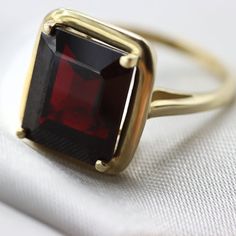 An Absolutely gorgeous Red Garnet Gold ring. Featuring a Prong set 6.5 Carat 10 x 12 Red Garnet natural Gemstone. The color is simply amazing as well as the clarity, This is a Grade AAA corundum Gemstone. When i saw the beauty of this gemstone i had to have it, I simply had to buy a few and make a few rings with them i could not escape its beauty! Each ring is hand made to your order from start to finish with the utmost attention to details, service and finish. We only have a few of these marvel Red Ring With Center Stone For Formal Occasions, Formal Red Birthstone Ring With Prong Setting, Formal Red Ring With Center Stone, Formal Ruby Crystal Ring Fine Jewelry, Classic Red Birthstone Ring, Formal Ruby Open Ring, Formal Red Sapphire Ring, Classic Ruby Open Ring Jewelry, Classic Red Birthstone Ring With Ethical Gemstones