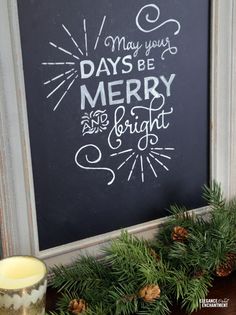 a chalkboard sign that says may you days be merry and bright with pine cones