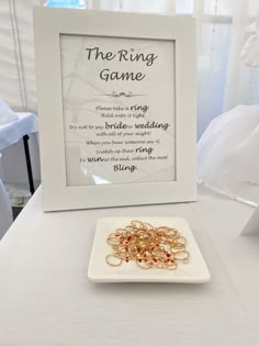 the ring game is displayed in front of a white plate with gold rings on it