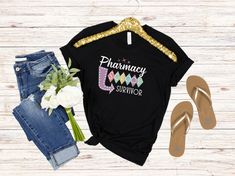 a t - shirt with the words pharmacy survivor on it next to sandals and flowers