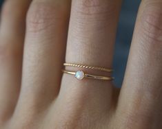 Handmade 3mm white opal 14k gold filled band ring✨🌚 Dainty and perfect minimalist piece! Stunning 3mm lab grown opal gemstones. Each stone is hand set into a bezel and polished for a beautiful shine finish. Opal means jewel. The energies of this stone will also encourage you to express your true self, in addition to feeling confident and comfortable in your own skin, and this will radiate in your words, thoughts, and actions. Material: 14/20 (karat/purity) gold filled Or solid 925 Sterling silv Minimalist Gold Opal Birthstone Ring, Gold Stackable Opal Ring For Everyday, Everyday Gold Stackable Opal Ring, Gold Opal Stackable Ring For Everyday Wear, Minimalist Opal Stackable Promise Rings, Dainty Gold Opal Ring In 14k, Dainty Gold Opal Ring In 14k Gold, Minimalist Gold Opal Ring As Birthstone, Minimalist Gold Opal Rings