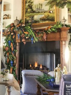 a living room with a fire place and christmas decorations on the mantel above it