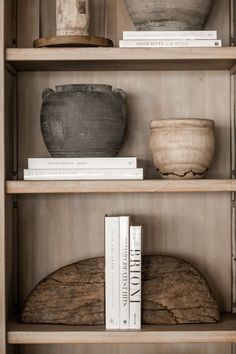 books and vases on shelves in a room