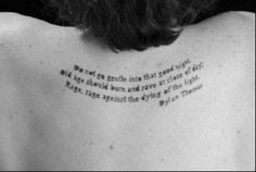 the back of a man's neck with a poem written on his left shoulder