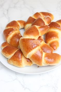 a white plate topped with lots of hot cross buns