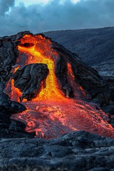 an active volcano erupts lava into the sky