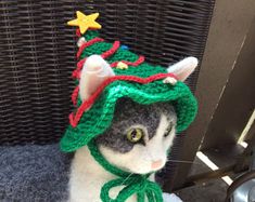 a stuffed cat wearing a christmas hat and scarf