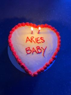 there is a heart shaped cake with candles on it