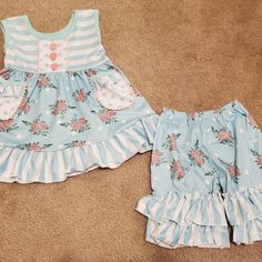 New In Package. Blue Floral Ruffle Shorts Outfit. Runs Generous To Size Marked. Top Has Pockets.. Sizes Available: 6-12 Month, 12-18 Month, 2t, 3t, 5-6, 6-7. 95% Cotton, 5% Spandex. Soft Material. Cute Ruffled Bottoms For Playwear, Blue Cotton Bottoms With Ruffle Hem, Spring Ruffled Bottoms For Playtime, Blue Cotton Bloomers With Ruffles, Spring Playtime Ruffled Bottoms, Cute Blue Summer Bloomers, Blue Ruffled Bloomers For Summer, Summer Blue Ruffled Bloomers, Playful Blue Ruffled Bottoms