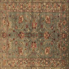 an antique rug with many different colors and designs on the carpet, including red flowers