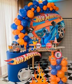 an assortment of balloons and decorations for a hot wheels birthday party