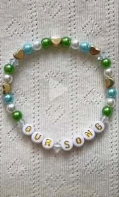 a beaded bracelet with words and pearls