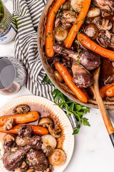 a plate with carrots, mushrooms and meat on it