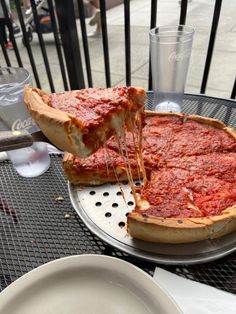 a deep dish pizza on a metal tray