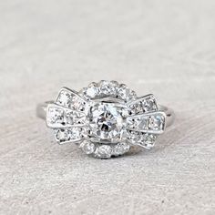 Antique Art Deco Diamond Cluster Engagement Ring .80 Ctw including .35 Ct Center! 14K White Gold Gorgeous! GIA G.G. Appraisal Incl 1,870 Usd! Gorgeous bright and sparkling 14k white gold diamond cluster ring. Boasting a unique and beautiful Art Deco style this ring holds a central .35 carat round brilliant cut diamond and an additional .45 carat set within the fan-like crown. The crown measures approximately 10.5 mm north to south and 16.2 mm east to west. It rises approximately 5.7 mm from the Vintage Rings Engagement, Wide Wedding Bands, Diamond Cluster Engagement Ring, Athens Ga, Cluster Engagement Ring, Right Hand Rings, Lovely Ring, Art Deco Diamond, Diamond Cluster Ring