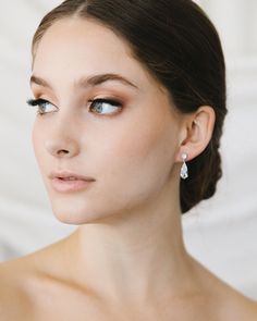 Glamour & elegance meet with our Tilly Dangle Earrings. Designed with a shimmering teardrop crystal, these earrings are perfect for the minimalist bride or bridesmaids. Cubic Zirconia Measures 1" in length Hypoallergenic, lead-free & nickel-free Style #4441 Bridal Jewelry Silver, Wedding Jewelry Crystal, Bridal Dangle Earrings, Bridal Earring, Minimalist Bride, Crystal Wedding Jewelry, 2025 Wedding, Crystal Earrings Wedding, Crystal Bridal Earrings