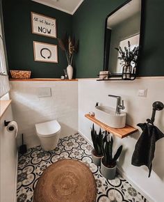 a white toilet sitting next to a sink in a bathroom