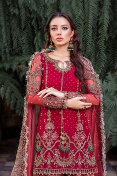 Royal Pakistani Bridal Outfit in Gharara Kameez Style is a traditional attire adorned with hand-crafted details of embellishments. Premium quality of the fabric and perfect stitching make this beautiful Gharara Dress an epitome of beauty and tradition. Bridal Kameez: The kameez in an alluring red shade is intricately adorned with embroidery, naqshi, and tilla. Hand-crafted details of Sitara and sequins give a glamorous touch to this perfectly stitched kameez in premium organza, making it a perfe Eid Lehenga With Naqshi For Traditional Ceremonies, Naqshi Lehenga For Eid And Traditional Ceremonies, Red Wedding Palazzo Set With Dabka, Eid Naqshi Dress For Traditional Ceremonies, Bollywood Naqshi Dress For Traditional Ceremonies, Bollywood Style Dress With Naqshi For Traditional Ceremonies, Semi-stitched Sharara With Intricate Embroidery For Eid, Sharara With Naqshi For Traditional Ceremonies And Festivals, Naqshi Chinon Lehenga For Festivals