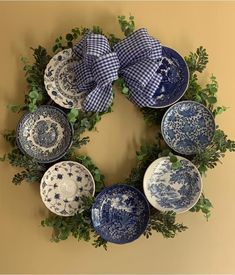 a wreath made out of blue and white plates