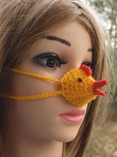 a mannequin head wearing a knitted chicken mask