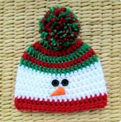 a crocheted snowman hat with a pom - pom on top