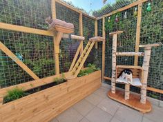 a cat house made out of wood and wire