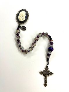 Easter Catholic gift Pocket Rosary Glass Purple bead Catholic Madonna centerpiece and bronze crucifix, Confirmation Catholic mom These one of a kind handmade rosaries are beautiful and would make a wonderful mothers gift, Reconciliation or Confirmation gift, Christmas gift! Also great for wedding gift or RCIA gift! The colors are gorgeous!  The antique bronze crucifix and Centerpiece Cameo are beautifully detailed. The rosary is made with a very sturdy No. 9 bonded nylon twine. Beaded Crucifix Rosary As Gift, Gift Rosary With Polished Beads And Cross, Handmade Bronze Rosary As A Gift, Bronze Rosary As Gift, Bronze Rosary With Round Beads As Gift, Antique Cross Rosary As Gift, Purple And White Crystal Mini Crucifix Rosaries, Amethyst Rosary, Rosary Beads Necklace