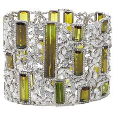 18kt white gold bracelet featuring 131.84 cts of peridot surrounded by marquise and round brilliant cut diamonds Diana M. is a leading supplier of top-quality fine jewelry for over 35 years. Diana M is one-stop shop for all your jewelry shopping, carrying line of diamond rings, earrings, bracelets, necklaces, and other fine jewelry. We create our jewelry from gemstones and diamonds of the highest quality (GIA certified) as well as the highest quality of gold and platinum to deliver magnificent, Luxury Green Hand Set Diamond Bracelet, Luxury Green Diamond Bracelet Hand Set, Luxury Green Cubic Zirconia Bracelets, Chic Scarves, Modern Bracelets, White Gold Bracelet, Stylish Hats, Colored Gems, Fine Jewelry Bracelets