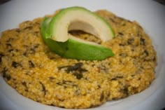 an avocado on top of some food in a bowl