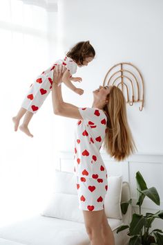 Snuggle up in style with our Matching Mother and Child Pajama Set! Crafted from 100% premium cotton, these white pajamas with adorable red heart patterns are designed for ultimate comfort and coziness. The set includes matching heart-patterned shorts and short-sleeved tops for both mom and child, making bedtime a delightful bonding experience. Perfect for family matching, our pajamas ensure that mom and daughter look cute together, whether it's for lounging at home or a fun photo session. Ideal Mommy And Me Matching Pajamas, Mommy Daughter Matching Pajamas, Cotton Sleepwear With Heart Print For Pajama Party, Cotton Sleepwear With Heart Print For Sleepover, Pajama Set Cotton, Heart Shorts, Moms And Daughters, Valentine's Day Heart Print Sleepwear, Red Heart Patterns