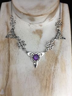 "I've fabricated an Irish Inspired necklace with a center Celtic knot which features an 8mm faceted gemstone of your choosing, with two Trinity component pieces on either side, and two Celtic stenciling components to compliment the trinity knots. The sterling chain of 14 inches is soldered to each end making the approximate length of this piece just a bit over 18\" total. The chain will have a sturdy lobster claw. If you want the necklace longer or shorter, please give me your desired length, an Anniversary Amethyst Necklace Hallmarked, Hallmarked Purple Necklaces For Gifts, Purple Hallmarked Necklaces For Gifts, Spiritual Amethyst Necklace For Anniversary, Gift Purple Hallmarked Necklaces, Spiritual Stone Setting Necklaces For Gifts, Necklace With Stone Setting For Gift, Spiritual Formal Birthstone Necklaces, Round Necklace With Stone Setting For Gift