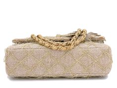 Exclusively from the 2010 runway is this very rare Chanel taupe beige raffia classic flap bag with camellia accents and brushed gold hardware. Exquisite attention has been made to the details - the quilts are made with straw/jute, the double woven chain strap is woven with straw fibers and there are two multi-media large camellia flowers on the front of the flap. Interior is made of red canvas with two side pockets - as a single flap bag, it is lightweight and spacious for such a collectible pie Camellia Flowers, 2010 Runway, Brushed Gold Hardware, Classic Flap Bag, Red Canvas, Woven Chain, Chanel Purse, Chanel Earrings, Vintage Chanel