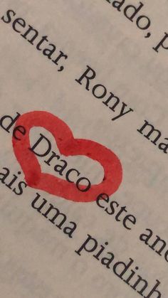 an open book with the words written in latin and spanish on it, including two hearts