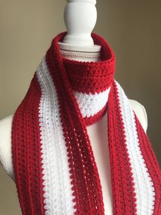 a red and white striped scarf on a mannequin