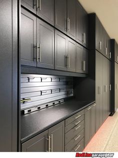 the cabinets in this kitchen are black and have drawers on one side, and doors on the other