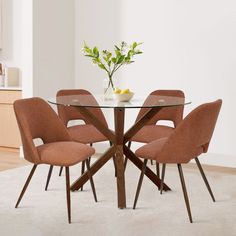 a glass table with four chairs around it