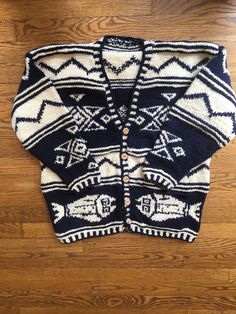 "Item: Thick knit wool cardigan sweater w/ flounder fish & tribal designs, hand pockets on front Material: Untagged, likely 100% Wool w/ Wood Buttons, likely hand knit Quantity: One (1) sweater Color: Off-White (Cream) & Navy Blue Condition: Great vintage condition, with no holes or other major issues. See photos. Approx. Sizing: Untagged and likely hand knit, we feel that this sweater fits most like a Medium / Large, but with a boxy fit in the body but shorter sleeves, so please check t Bohemian Knit Cardigan With Fair Isle Pattern, Bohemian Fair Isle Knit Cardigan, Blue Wool Knitted Cardigan, Blue Knitted Wool Cardigan, Nordic Style Long Sleeve Knitted Cardigan, Bohemian Knitted Winter Outerwear, Bohemian Knit Winter Cardigan, Bohemian Winter Knit Cardigan, Blue Fair Isle Pattern Outerwear For Fall