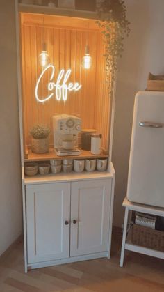 a coffee bar is lit up with the word coffee on it's display shelf