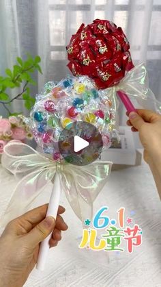 a person holding a lollipop bouquet in their hand