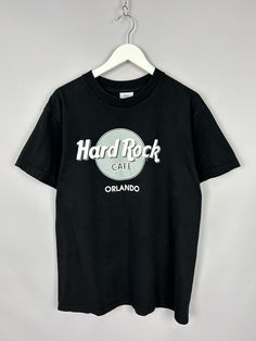 Vintage 90s Hard Rock Cafe Orlando Big Logo T Shirt RARE y2k Size M P2P 20" The perfect T-shirt! Black color way A must have piece Excellent used condition, without any defects! PLEASE CHECK MEASUREMENTS!! pit2 pit: 20" inches \ 51 cm length on the back: 26'7" inches \ 68 cm shoulders: 19'2" inches \ 49 cm If u have any questions please contact me before purchase Cafe Vintage, Vintage Cafe, Logo T, Rock Shirts, Rock Cafe, Hard Rock Cafe, Logo T Shirt, Hard Rock, Tshirt Logo