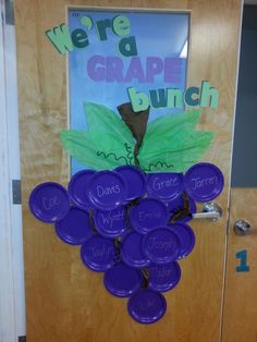 a bunch of purple frisbees sitting on top of a door with the words we're grape bunch