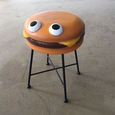 an odd looking stool with googly eyes and a mustache on it's face