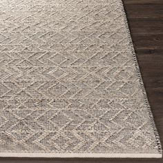 a white rug on top of a wooden floor