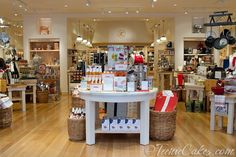 a store filled with lots of items on top of a hard wood floored floor