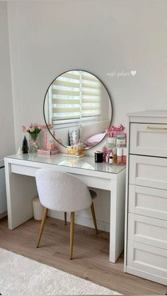 a white desk with a mirror on top of it next to a dresser and chair