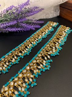 Kundan Antique payal set (pair). Brass made very flexible . Clear reverse stone and antique base . About 9 inch long each and 4.5 inch closed. One inch thick with bell. Traditional Beaded Toe Ring Anklets, Traditional Gold Beaded Anklets, Traditional Kundan Anklets With Stone Work, Traditional Stone Work Anklets For Festivals, Festive Kundan Anklets With Stone Work, Traditional Festive Anklets With Stone Work, Festive Traditional Anklets With Stone Work, Traditional Stone Work Anklets For Festive Season, One Inch